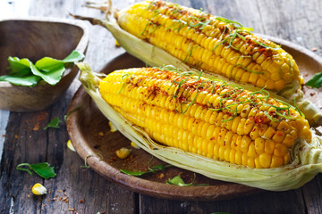 Steamed corn with ingredient herb on wooden plate