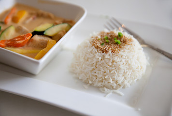 The plate of boiled rice with meat on white plate