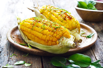 Steamed sweet corn whith ingredient herb on wooden plate