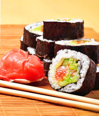sushi, rolls, ginger and chopstick on bamboo mat