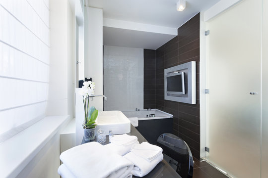 Luxury bathroom interior with wall mounted tv 