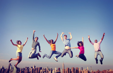People Jumping Friendship Happiness City Concept