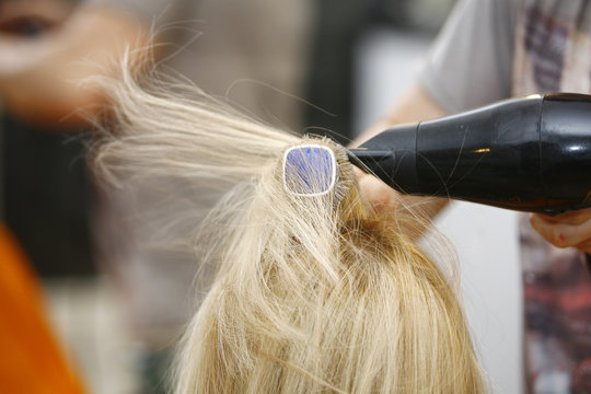 Hairstylist Drying Hair Blonde in Salon