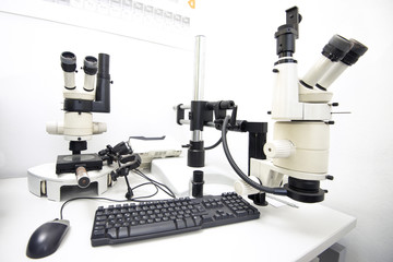 laboratory equipment, two microscopes on a desk