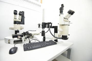 laboratory equipment, two microscopes on a desk