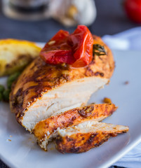 cut chicken curry baked with vegetables on a white plate