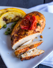 cut chicken curry baked with vegetables on a white plate