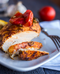 cut chicken curry baked with vegetables on a white plate