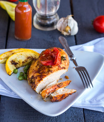 cut chicken curry baked with vegetables on a white plate