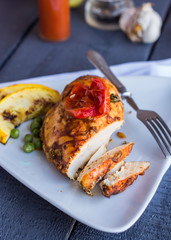 cut chicken curry baked with vegetables on a white plate