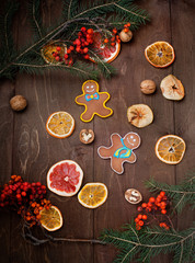 Obraz na płótnie Canvas dried fruits and gingerbread painted on dark wooden background