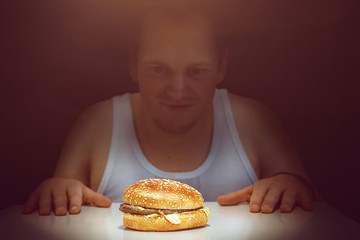Guy stares at his burger