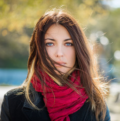 Beautiful young woman with blue eyes. Autumn portrait.