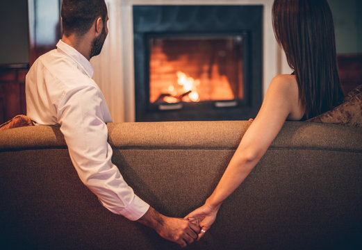  romantic couple sitting front  fireplace