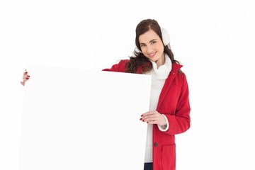 Happy brunette showing white poster