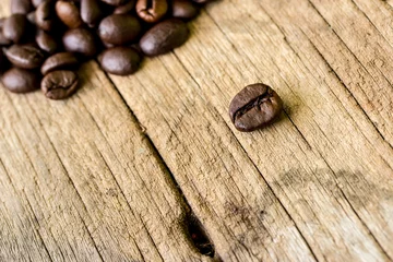 Fotobehang coffee grains on grunge wooden background © kurapy