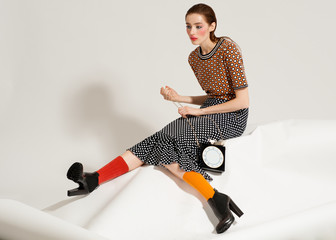Fashion model pose on light background