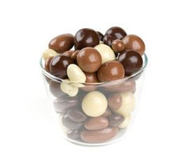 chocolate covered nuts and raisins isolated on white