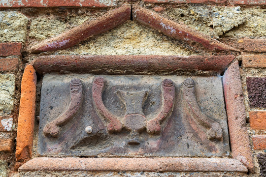 Relief image of phalluses on brothel wall in Pompeii, Italy. House exterior detail.