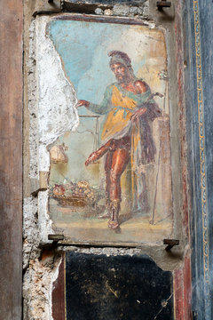 Ancient Roman fresco with god Priapus in Pompeii, Italy