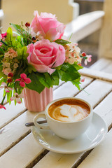 Coffee and rose flower on the white table