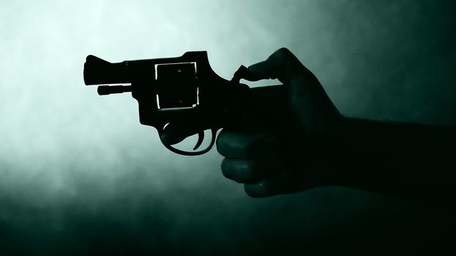 silhouette of a mans hand with a handgun,real time