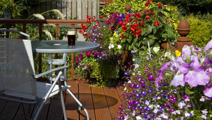 Fototapeta na wymiar Beer, table and chair in summer garden
