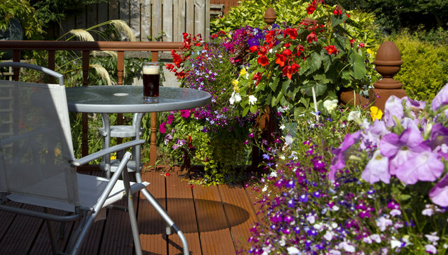 Beer, table and chair in summer garden