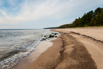 Shoreline of Baltic sea beach with rocks and sand dunes