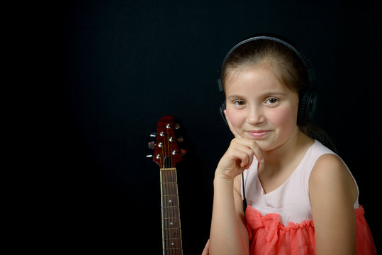 a little girl listening to music with headphones