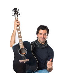 Handsome man with guitar over white background