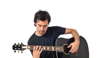 Handsome man with guitar over white background