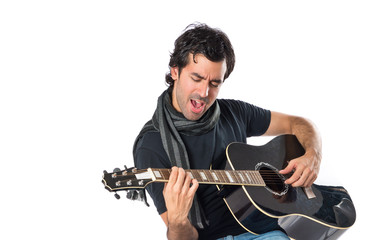 Obraz premium Handsome man with guitar over white background