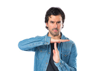 Man making time out gesture over white background