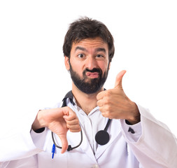 Doctor making a good-bad sign over white background