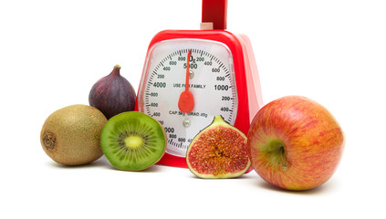 Ripe fruits and kitchen scales isolated close up on white backgr