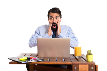 Businessman in his office doing surprise gesture