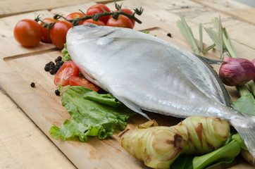 fish and vegetables on kitchen board