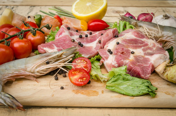 Fresh meat ,seafood  and vegetables on kitchen board