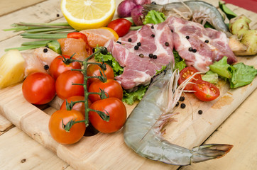 Fresh meat ,seafood  and vegetables on kitchen board