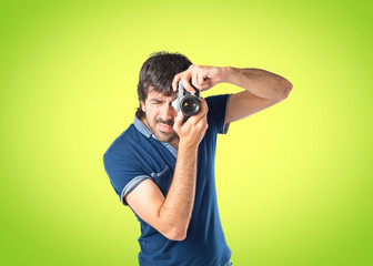 Fototapeta premium Man photographing over green background