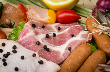 Fresh meat sausages  and vegetables on kitchen board