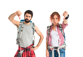 Backpacker making a good-bad sign over white background