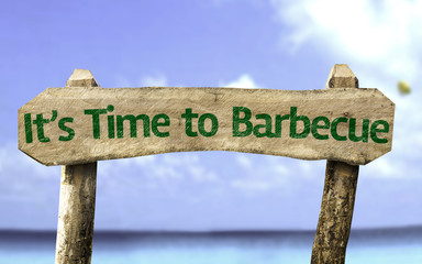 It's Time to Barbecue wooden sign with a beach on background