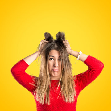 Pretty girl frustrated over yellow background