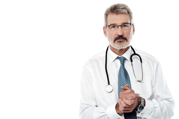 Senior male doctor keeping hands clasped