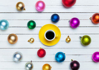 Naklejka na ściany i meble Coffee cup and christmas balls on white background.