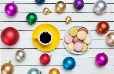 Cup of coffee and macaron with christmas toys on whte background