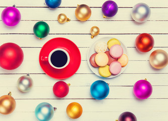 Cup of coffee and macaron with christmas toys on whte background