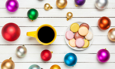 Naklejka na ściany i meble Cup of coffee and macaron with christmas toys on whte background